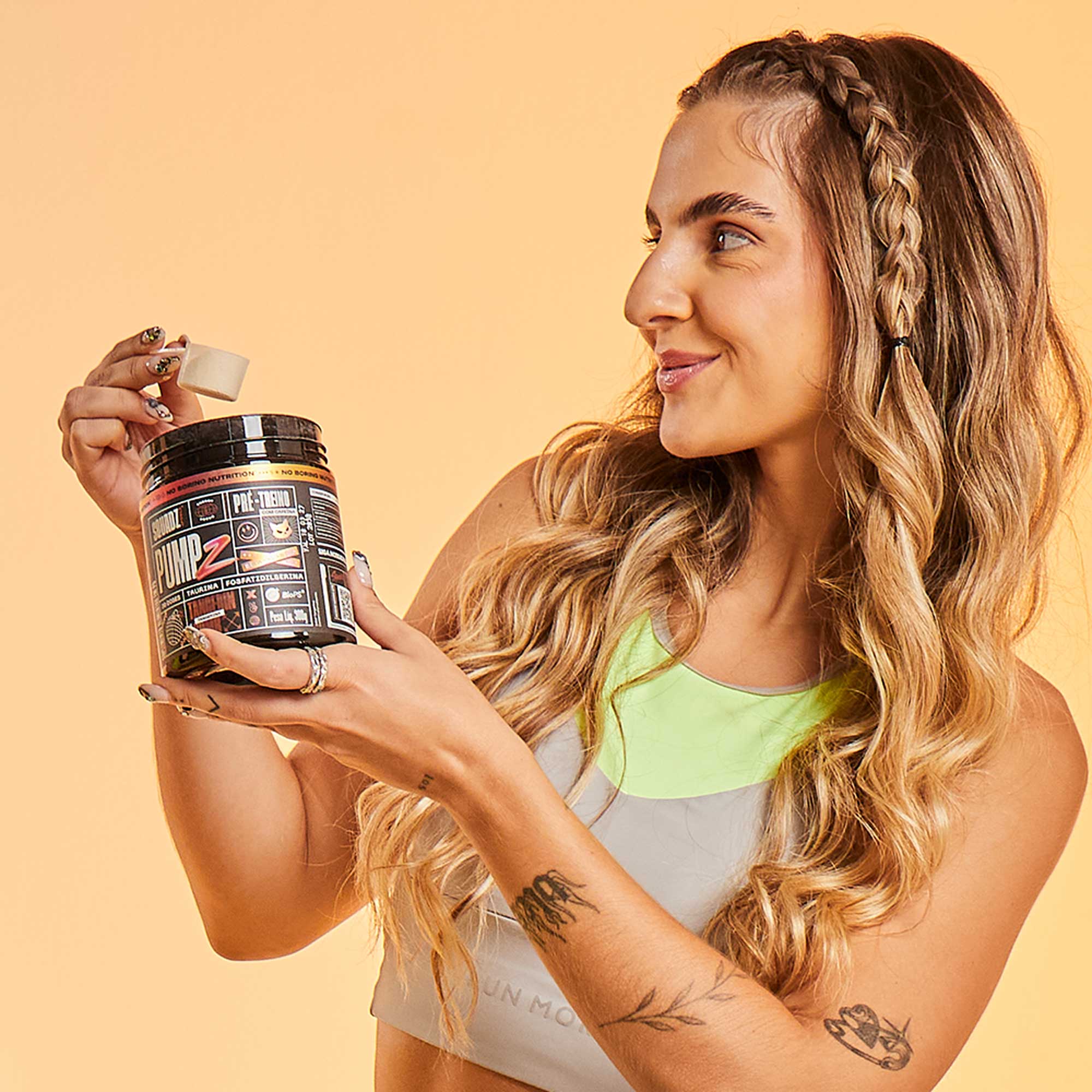 PUMP-Z Pré-Treino Tangerin Bomb 300g — Mulher com o pote
