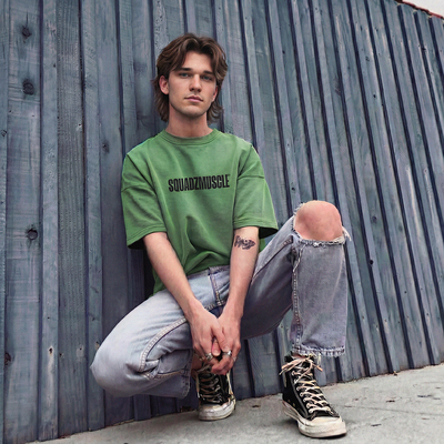 Camiseta Oversized Verde SQUADZ MUSCLE — Homem agachado com a camiseta